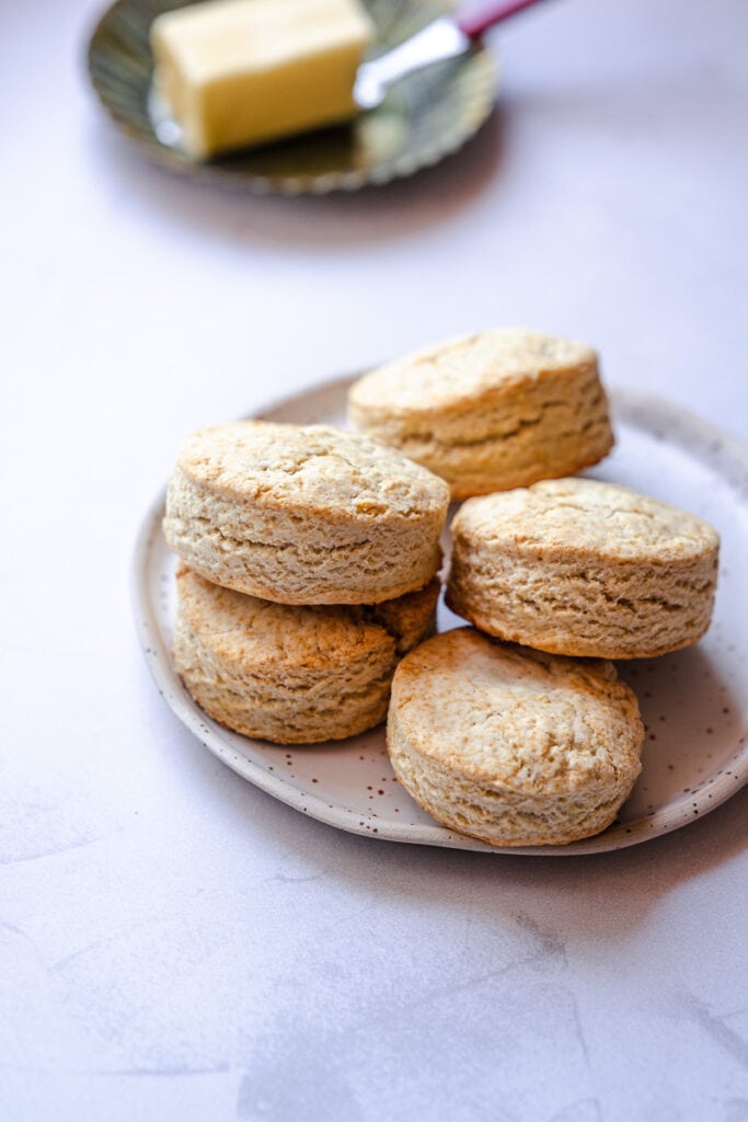 defined layers show on a stack of flaky soft gluten free biscuits stacked on a plate