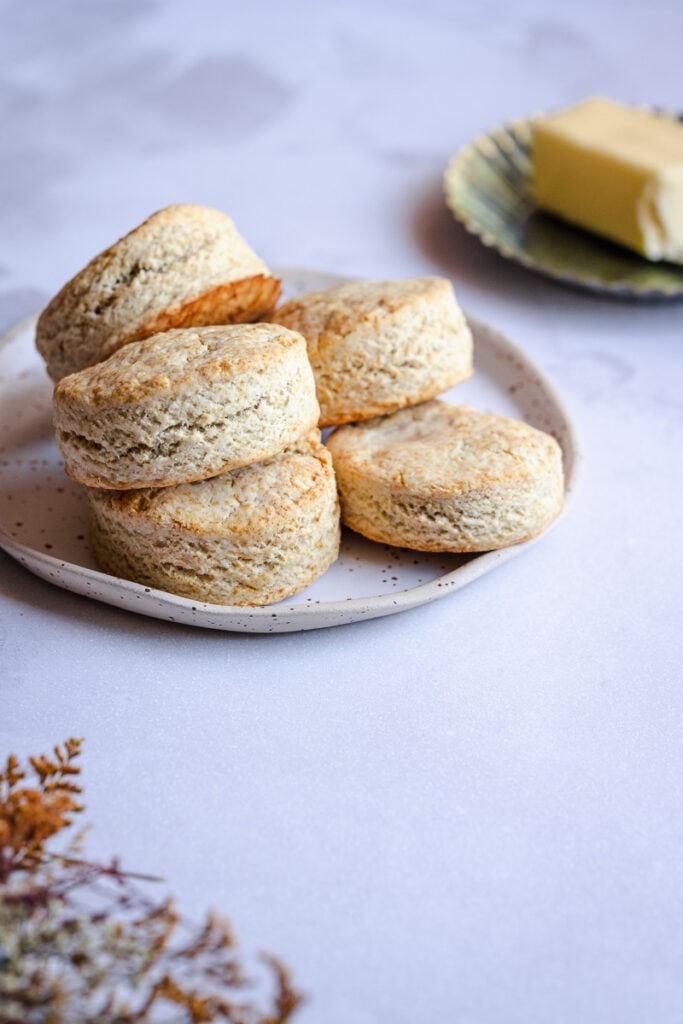 a stack of gluten free biscuits rest on a ceramic plate