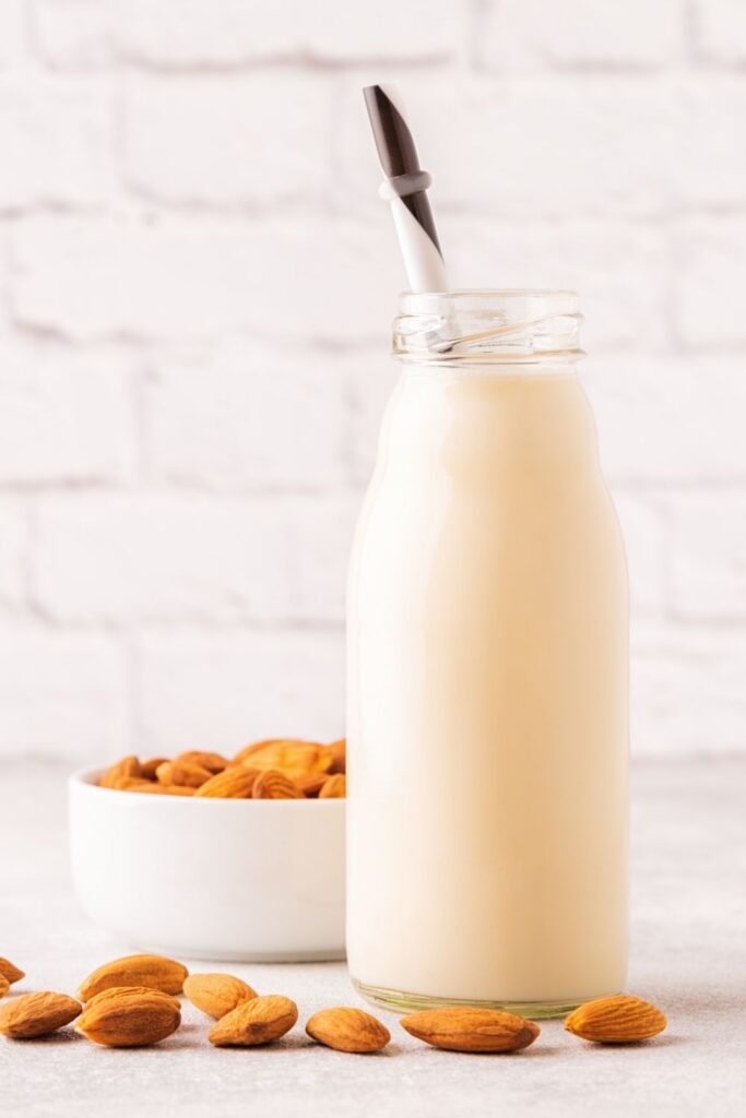 a clear carafe of freshly made almond milk