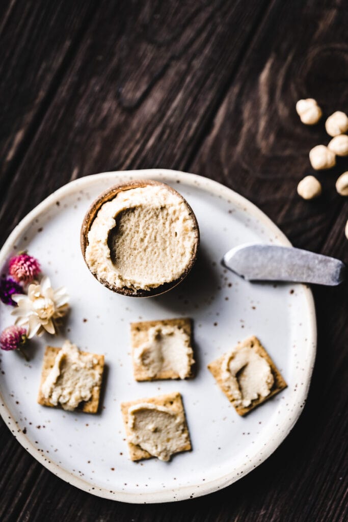 a small bowl of hazelnut cream cheese resting on a white plate