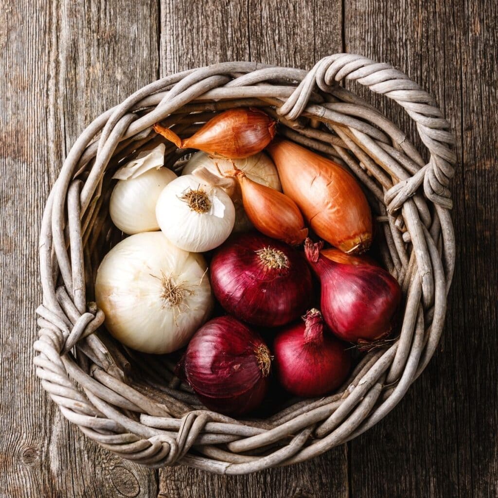 a wooden basket filled with onions