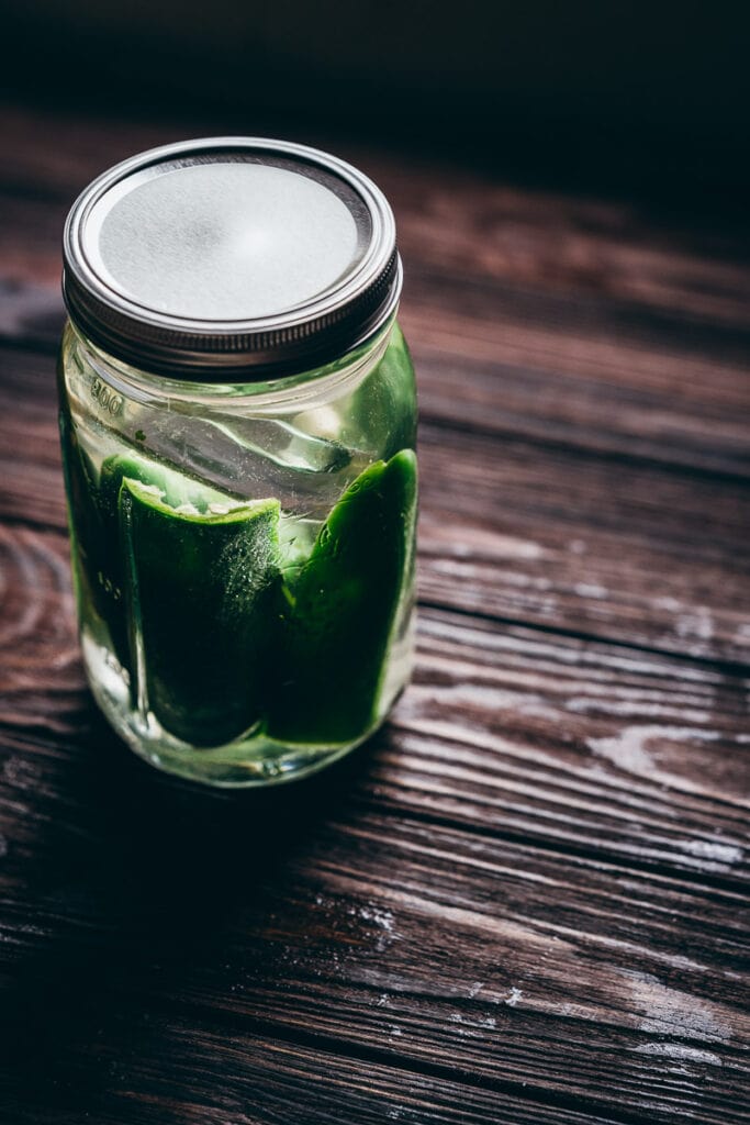 jalapeno peppers and garlic fermenting in a jar