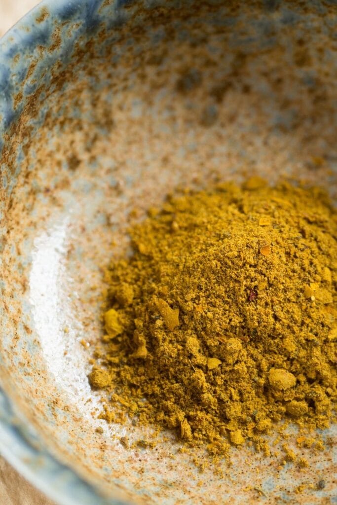 a bowl of curry powder as a turmeric substitute