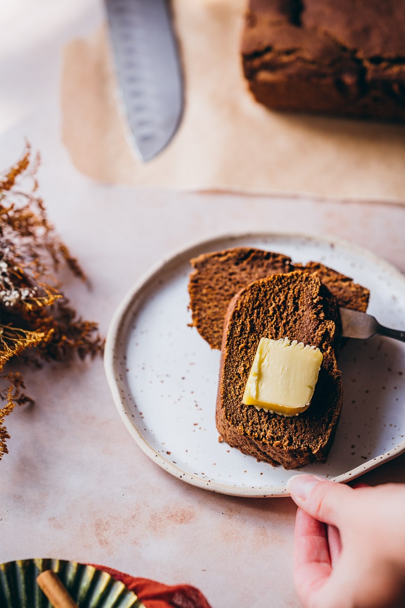 slices of teff flour pumpkin bread with dollops of butter