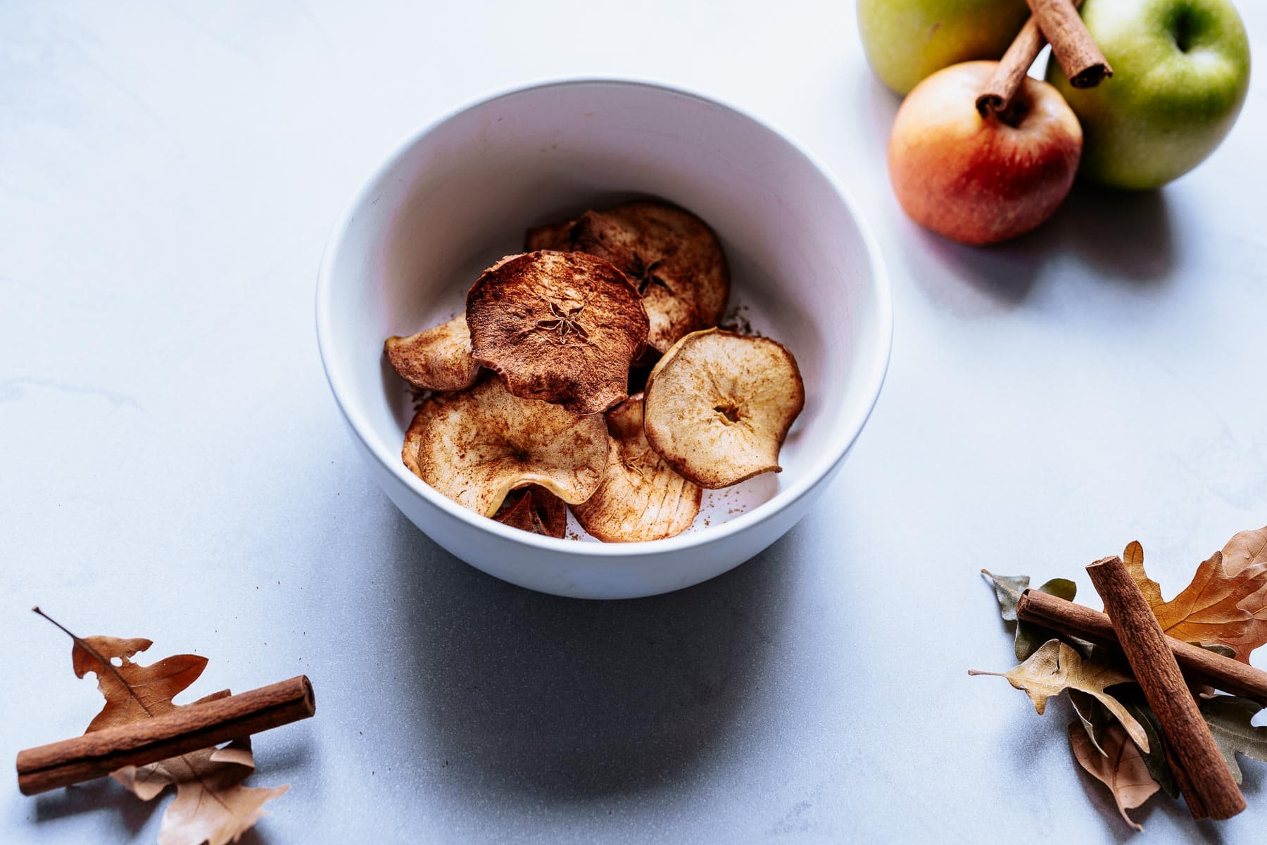 a white bowl of air fryer apple chips