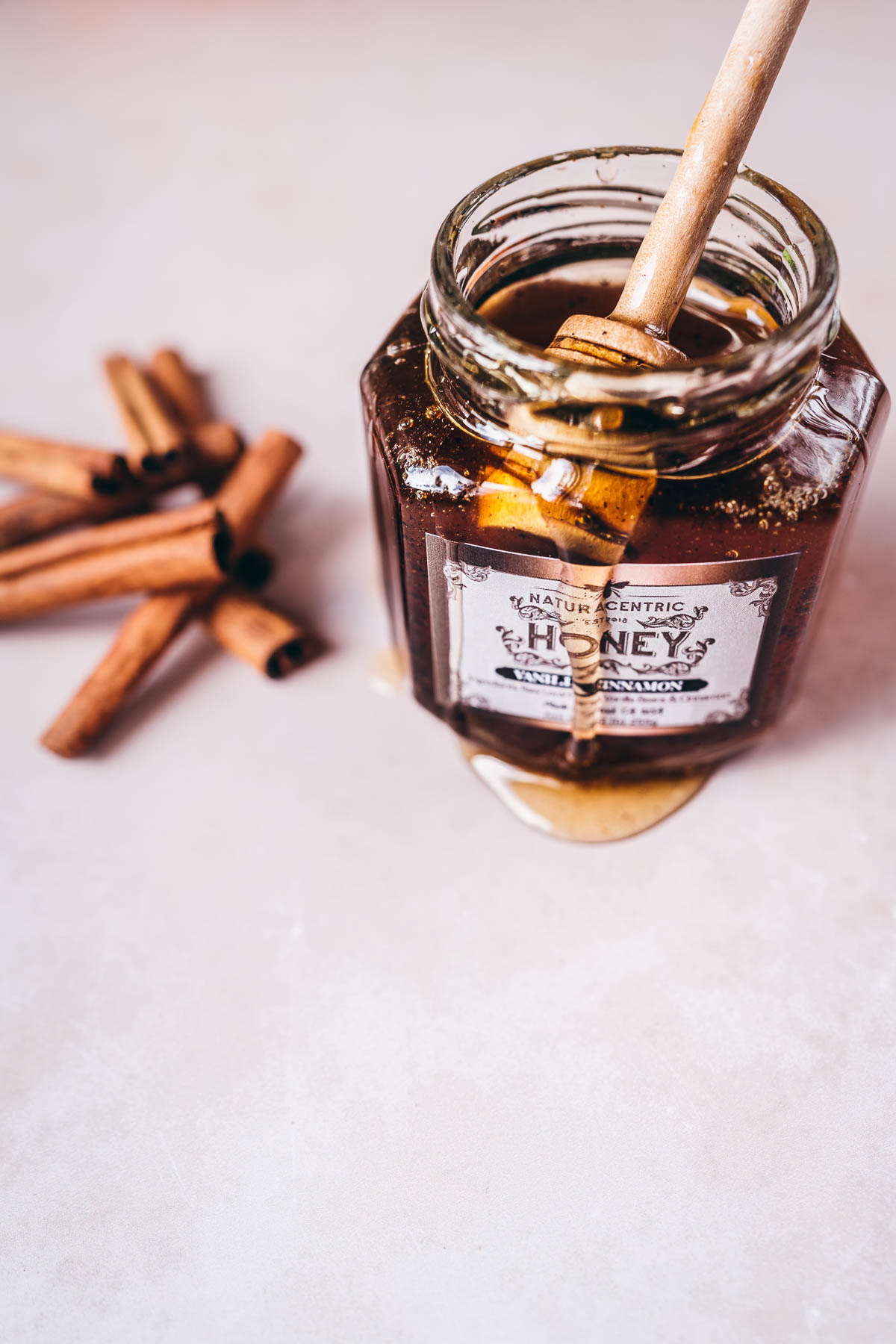 a jar of naturacentric vanilla cinnamon infused raw honey