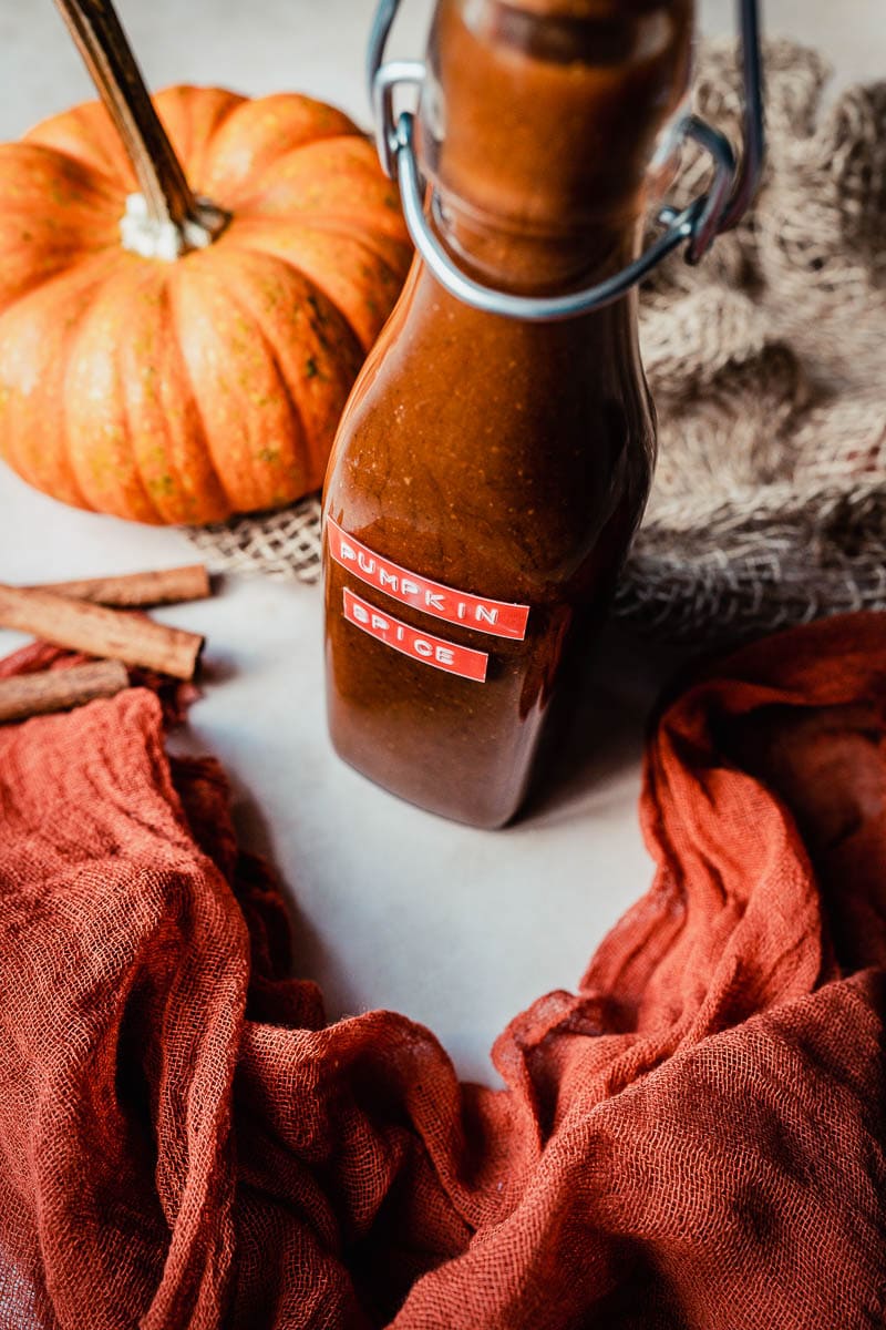 a tall bottle filled with homemade pumpkin spice syrup recipe 