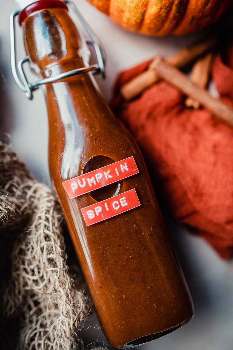 a close up shot of an orange label on a bottle that says pumpkin spice