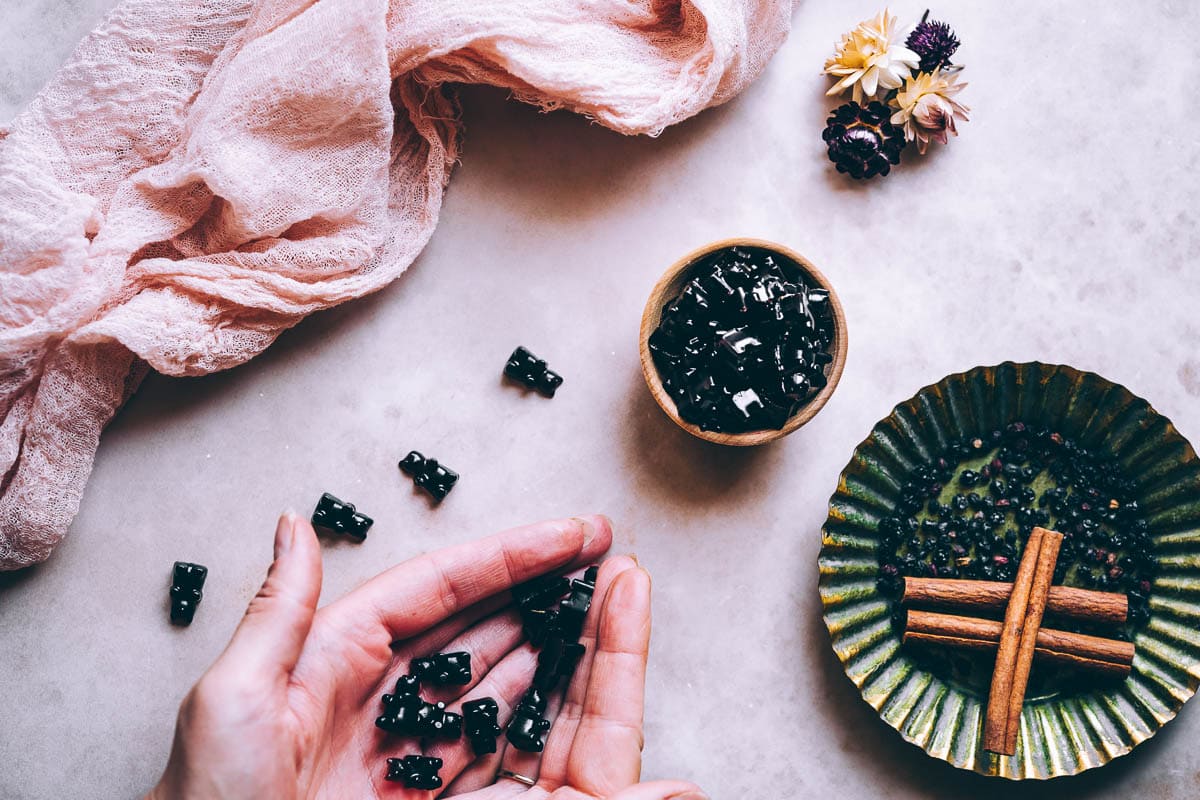 hands cupping a bunch of elderberry gummy bears