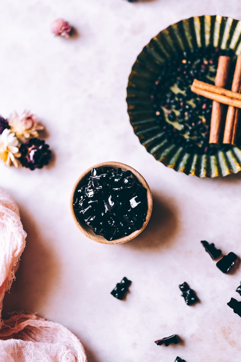 vegetarian elderberry gummies fill a small wooden bowl