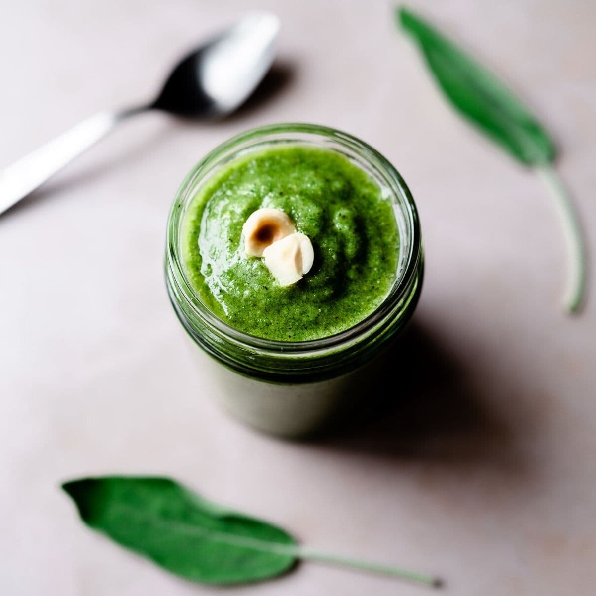 vibrant green sage pesto topped with crushed hazelnuts