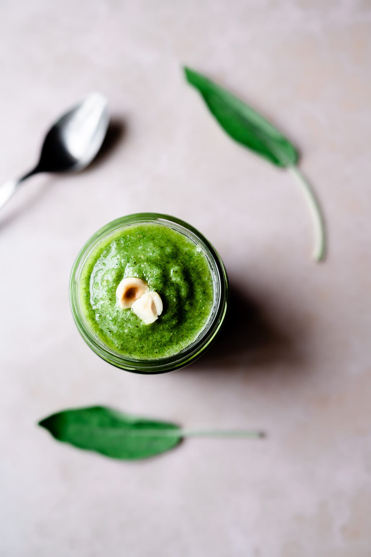 top view of vegan sage pesto topped with hazelnuts