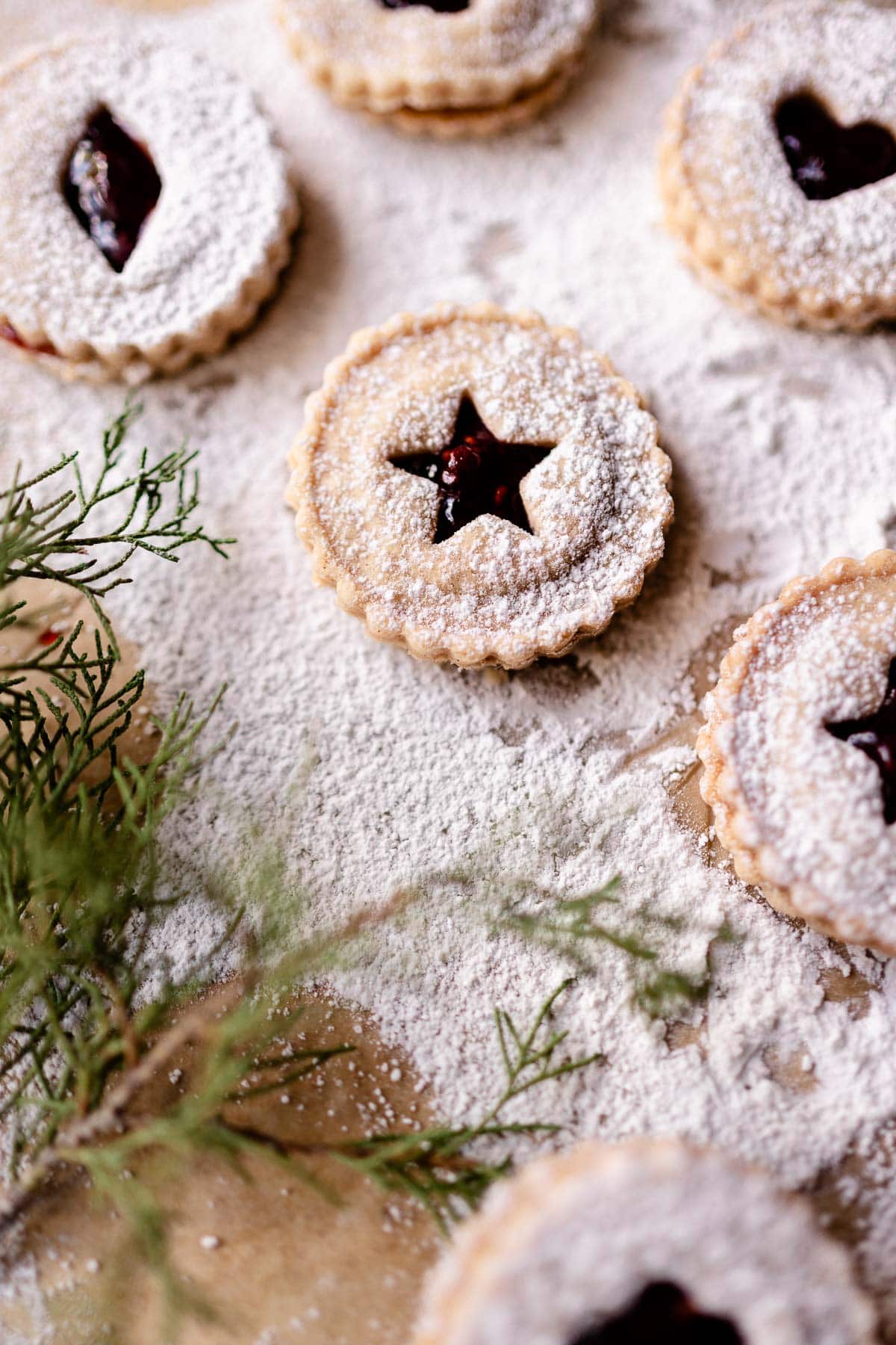 a gluten free linzer cookie with a star cut out shape