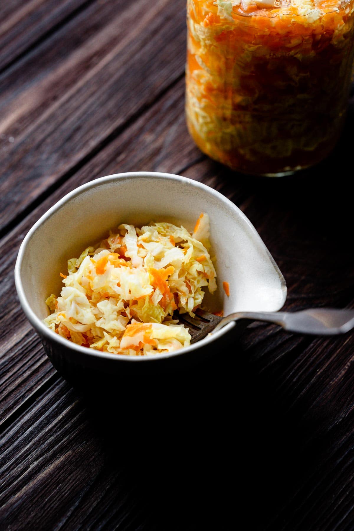 a white bowl of pickled cabbage