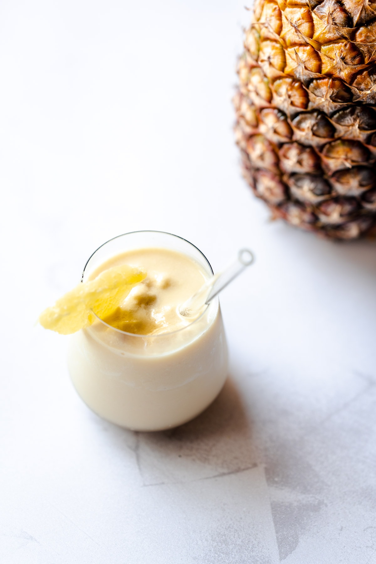 a shot glass of refreshing pineapple smoothie