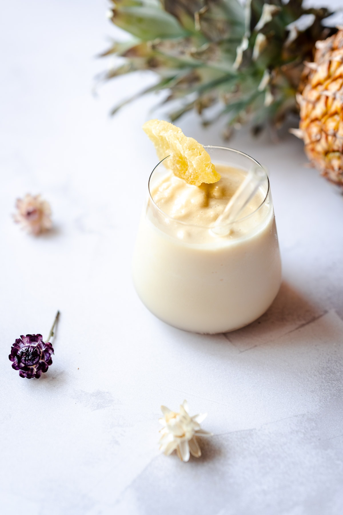 pineapple smoothie garnished with dried pineapple ring