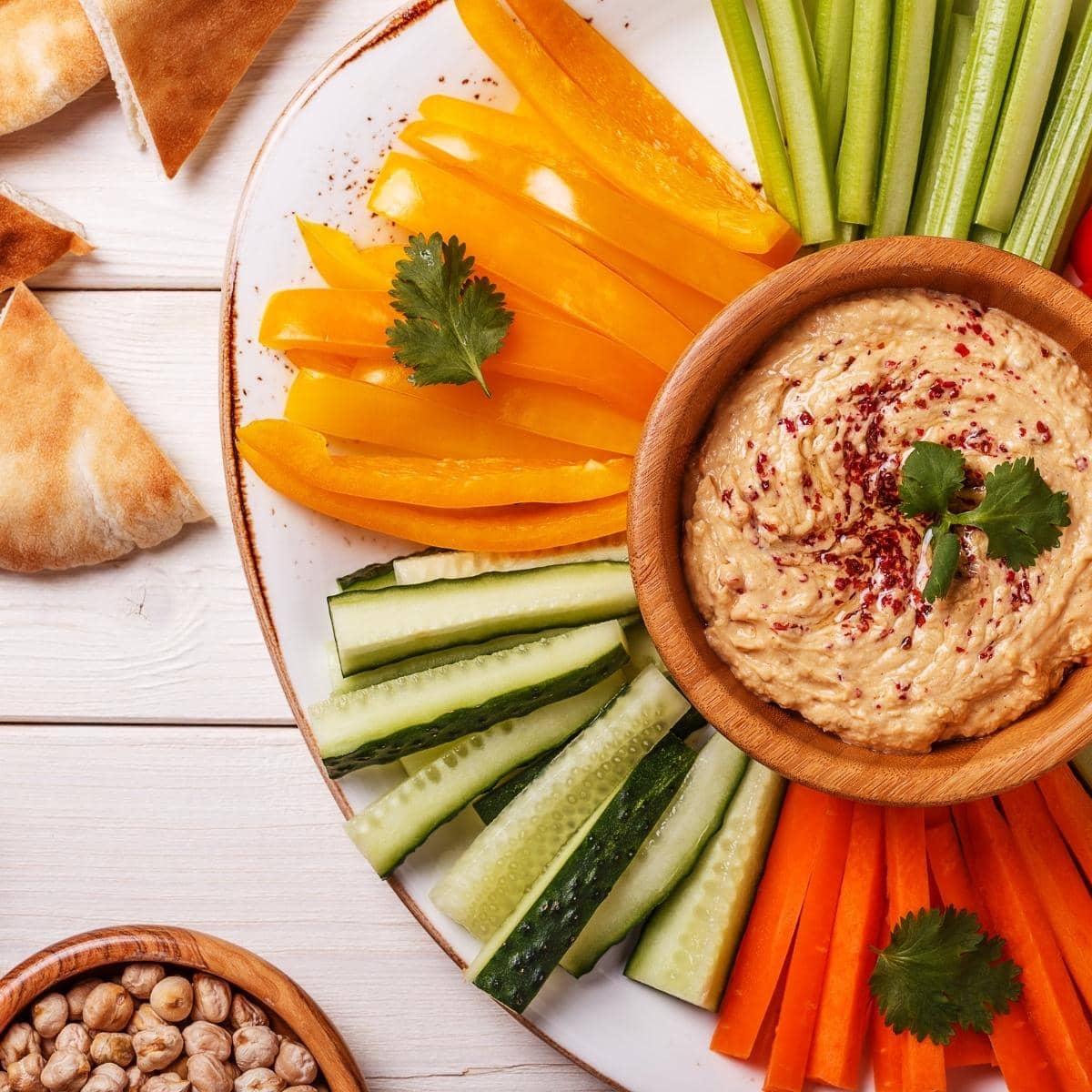 serve gluten free hummus with fresh cut veggies and pita bread.