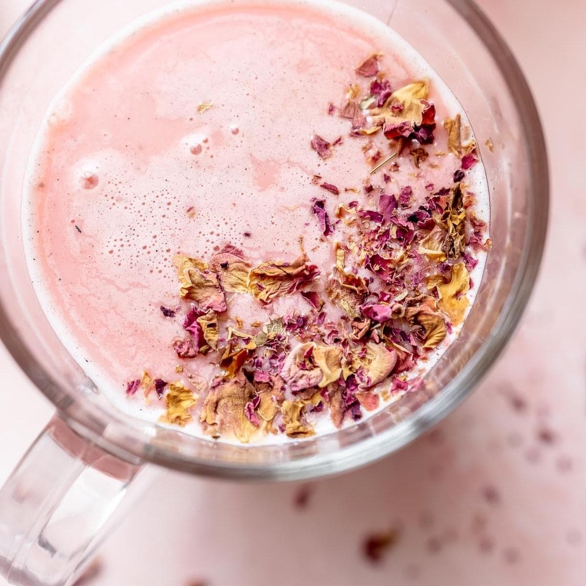 pink moon milk topped with crushed rose petals