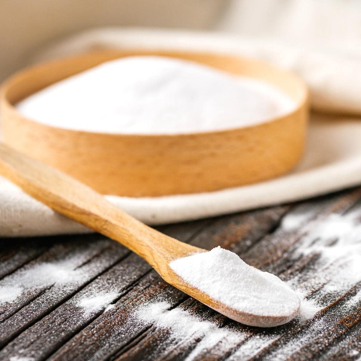 baking powder resting on a wooden spoon.