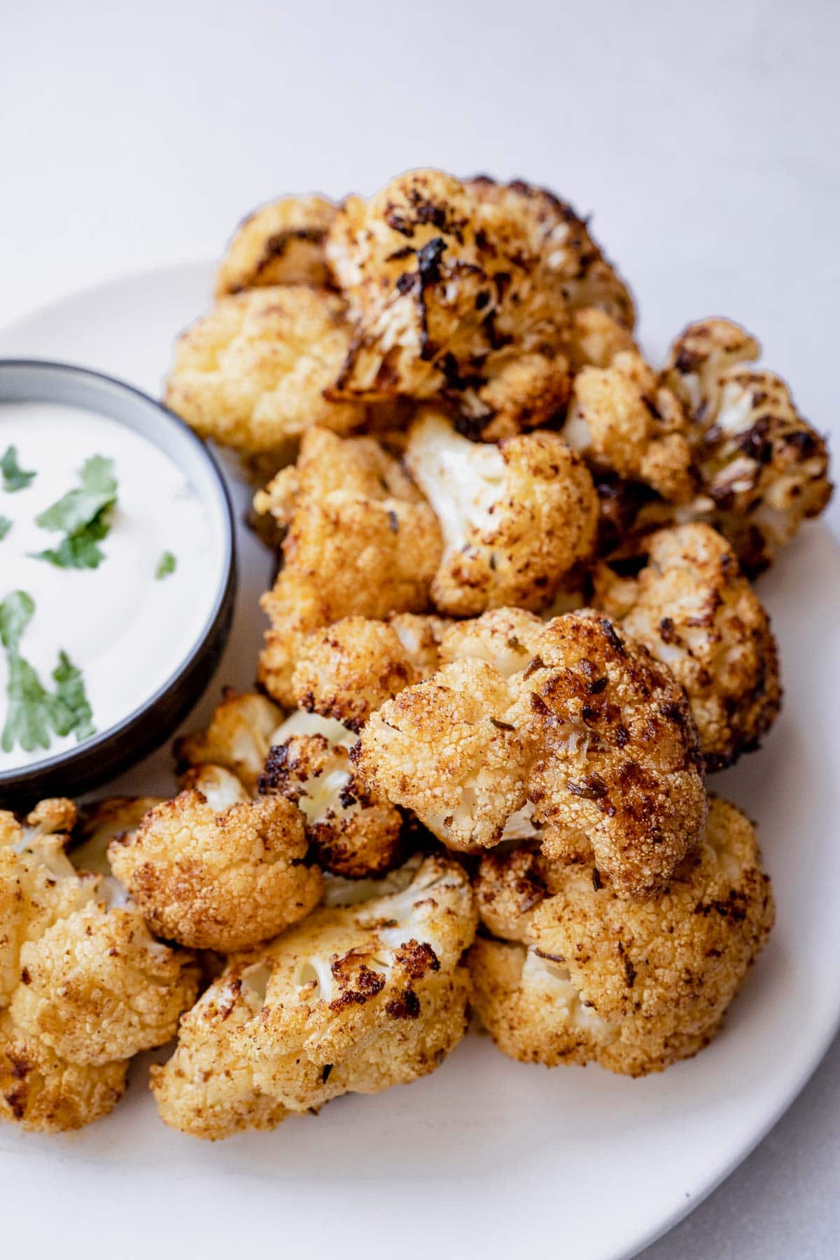 A close view of crispy cauliflower florets baked in an air fryer.