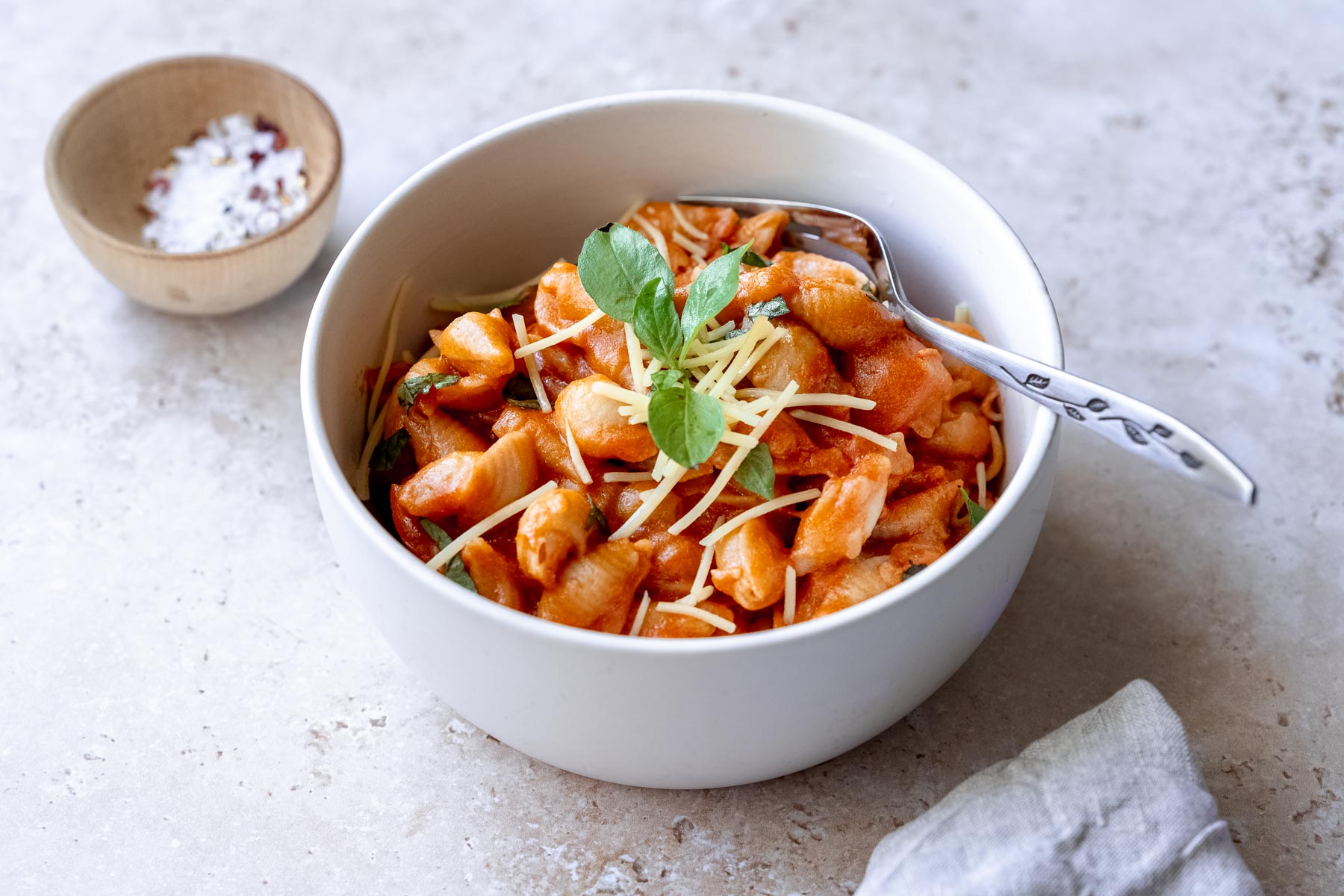 spicy gigi hadid pasta recipe garnished with basil, cheese and red pepper flakes.