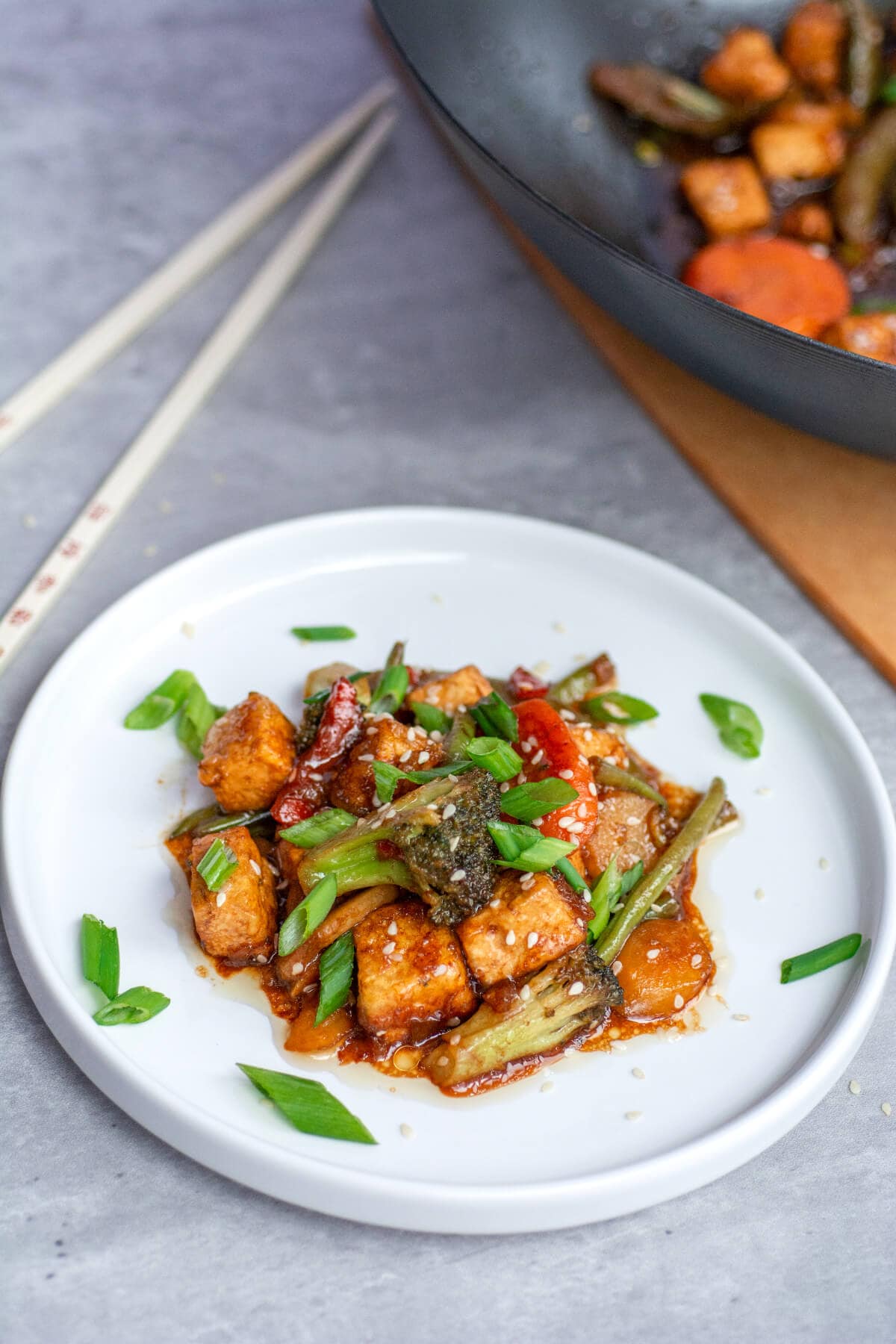 teriyaki tofu stir fry recipe on white plate garnished with green onions