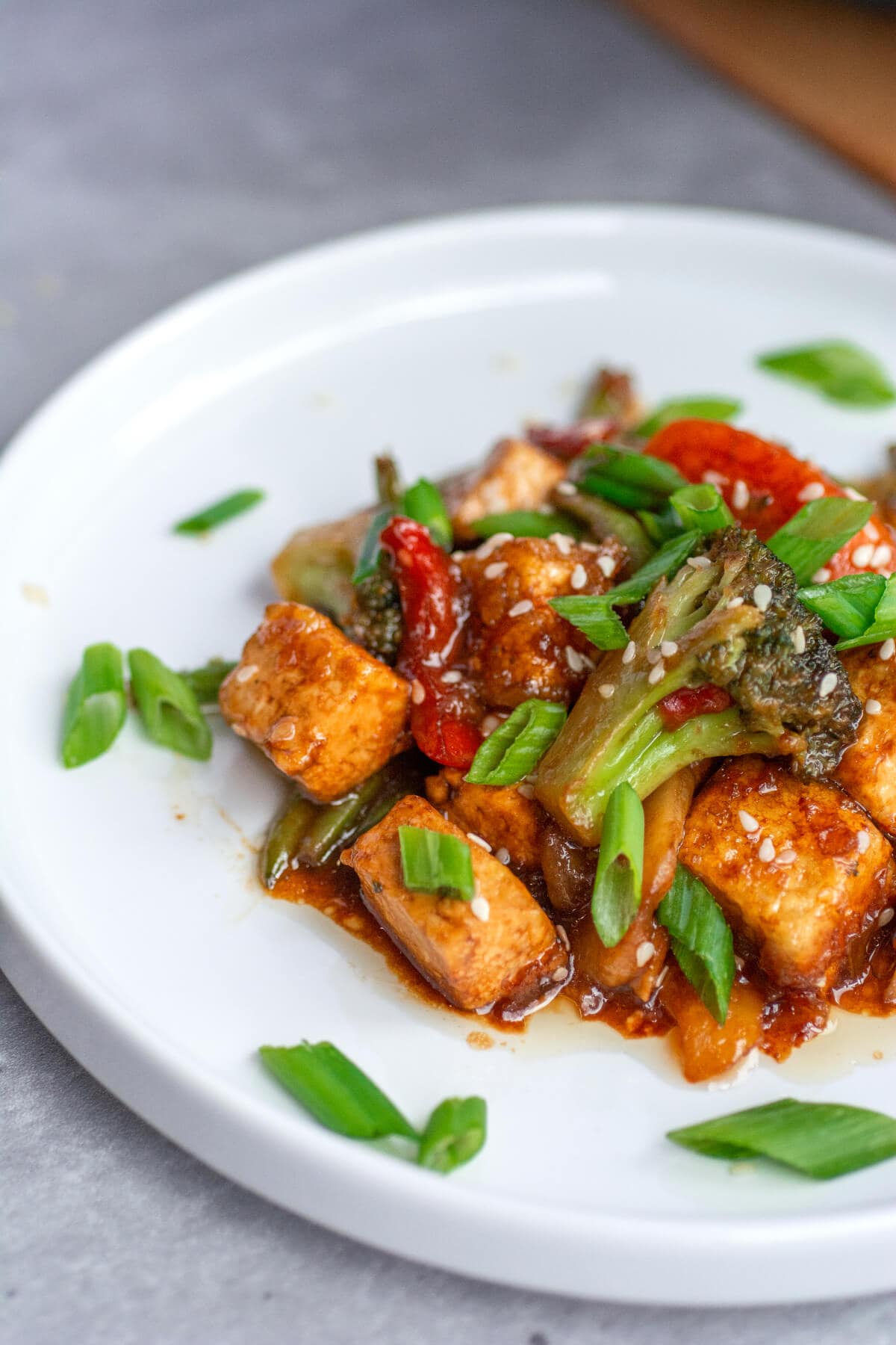 teriyaki tofu with stir fry veggies on white plate