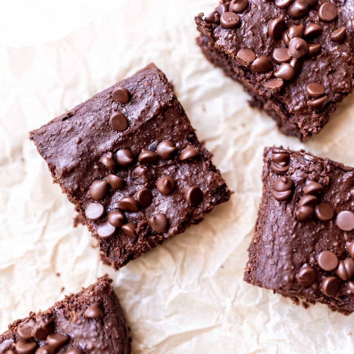 a close up shot of black bean brownies studded with mini chocolate chips.