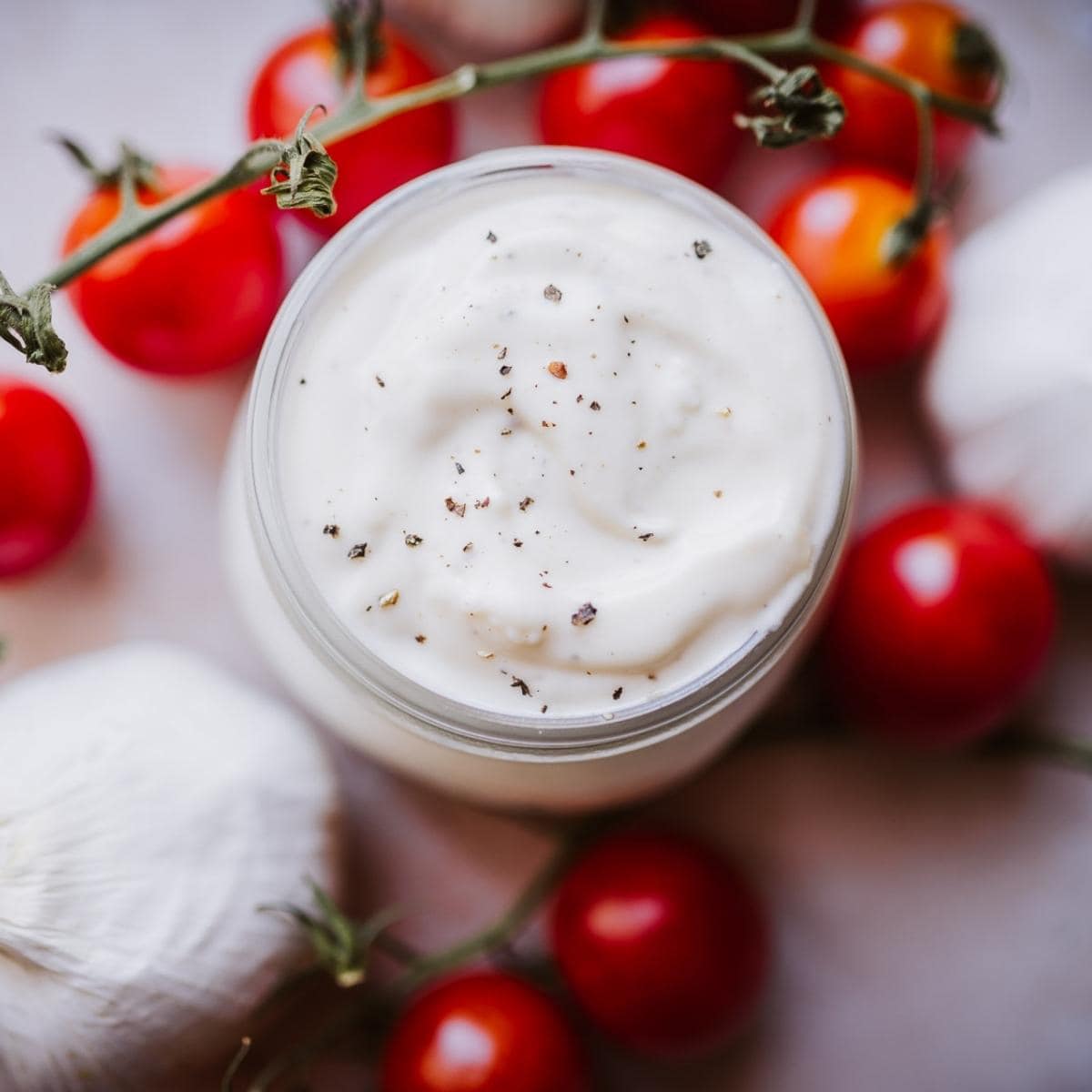 top view of a white creamy aioli sauce for dipping pizza in.