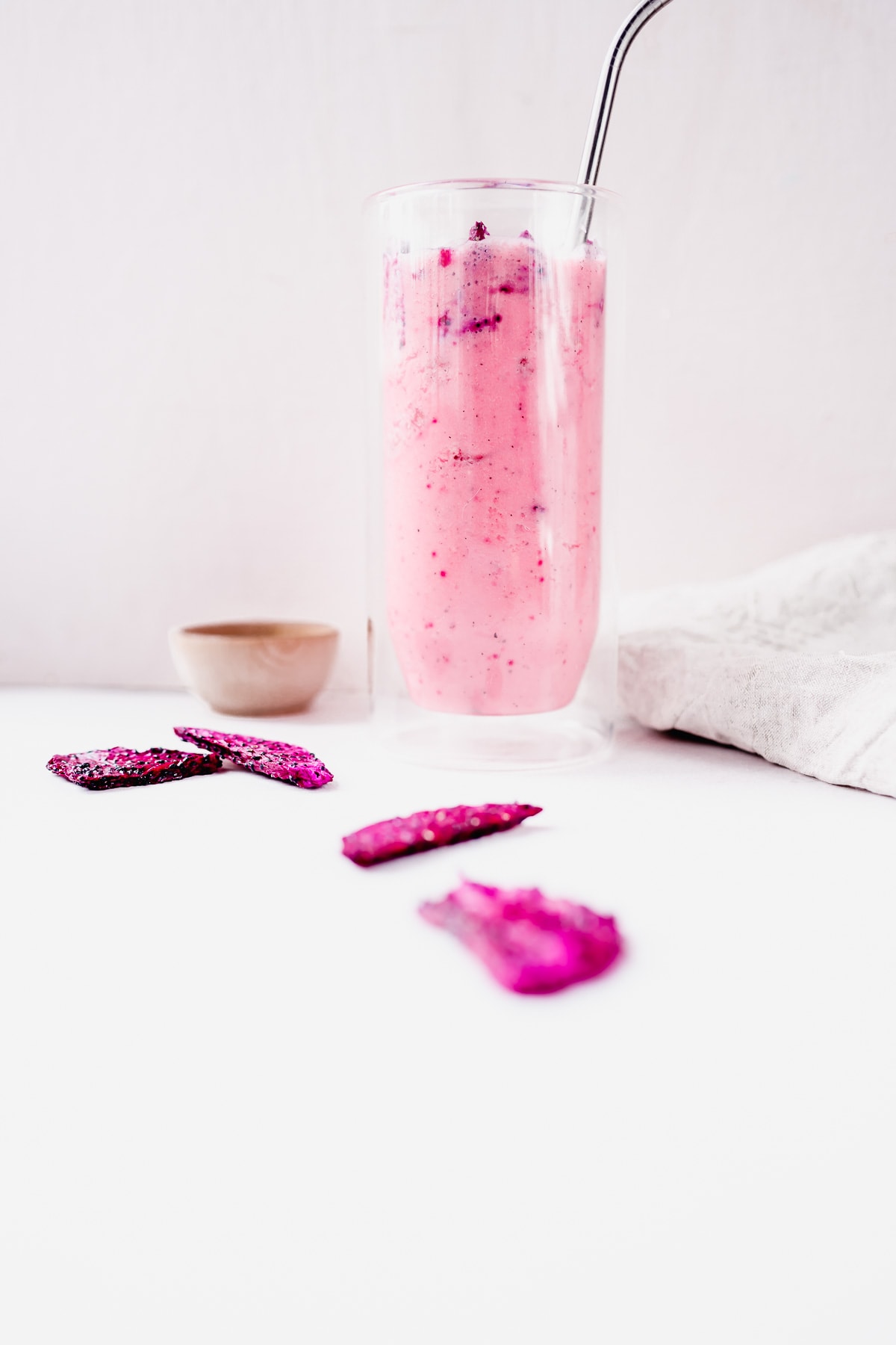 creamy and refreshing starbuck dragon fruit drink copycat recipe in a tall clear glass garnished with dragonfruit.