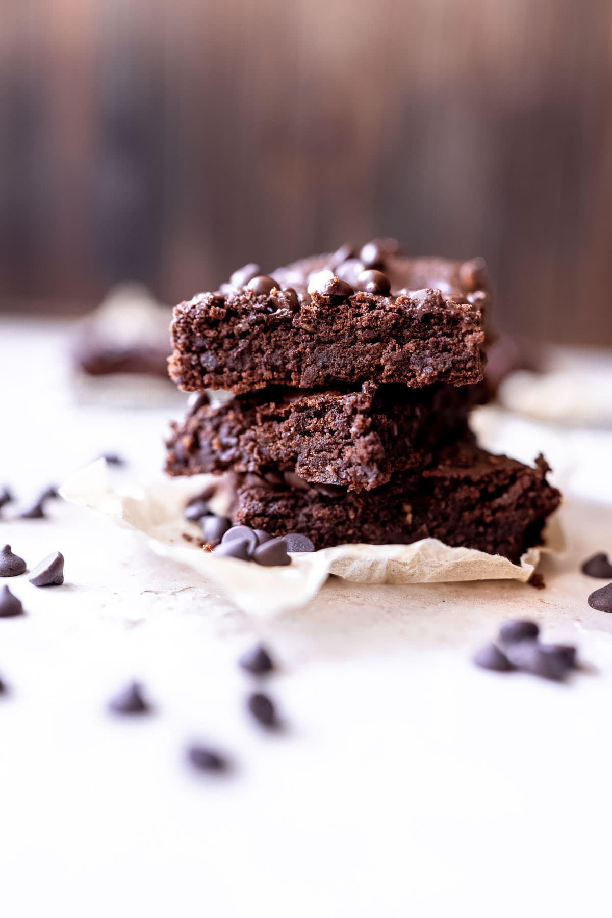a stack of gluten free black bean brownies studded with chocolate chips.