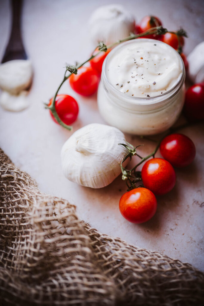 white creamy garlic aioli dusted with black pepper.