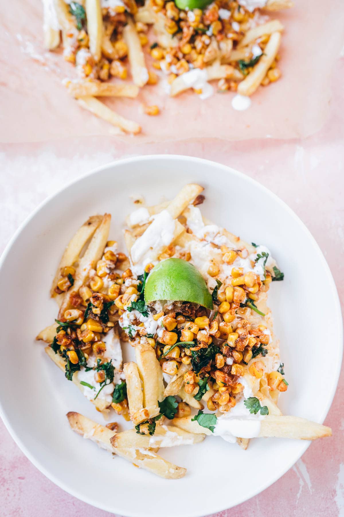 a white ceramic bowl filled with mexican street corn fries.