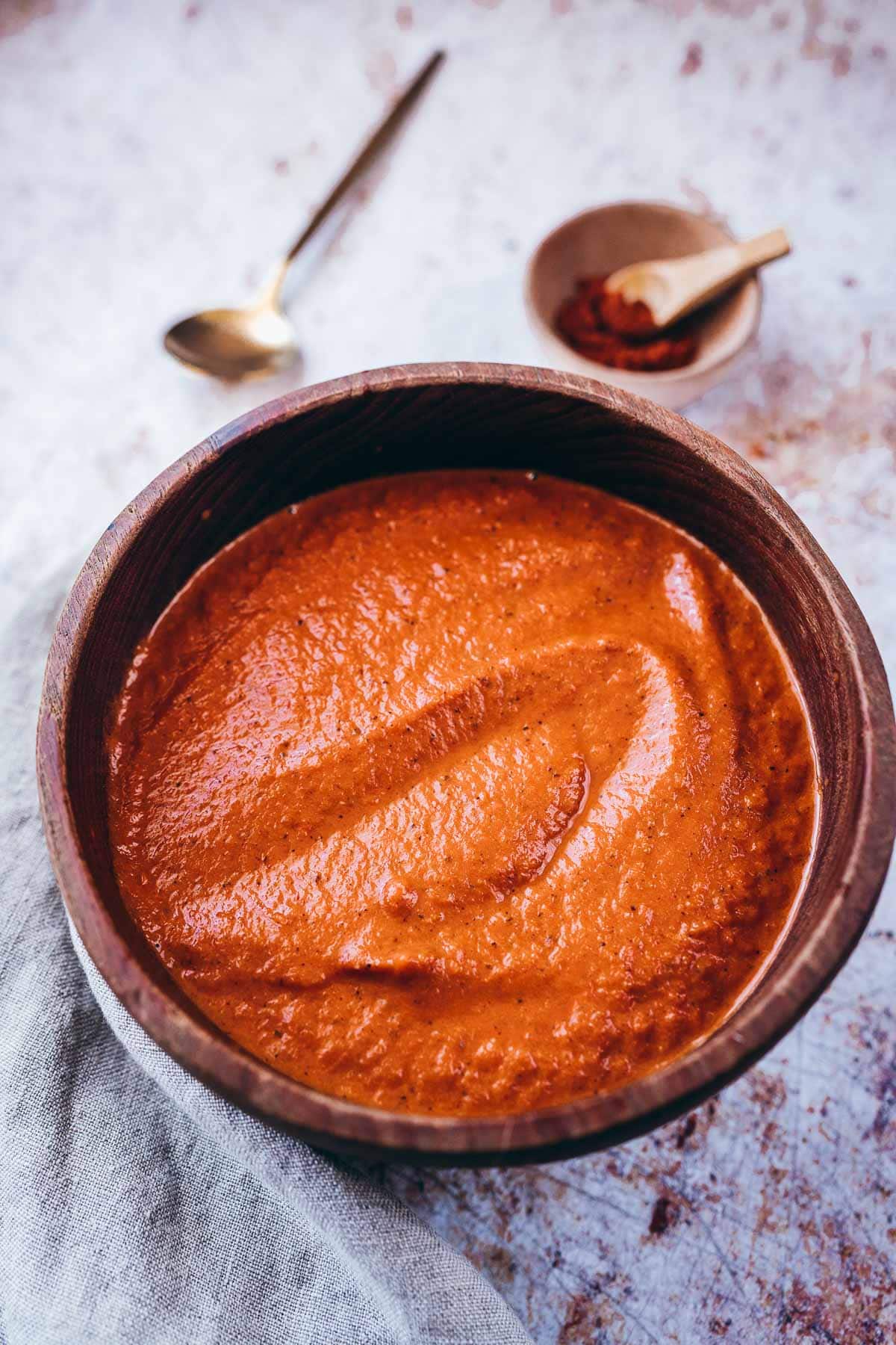 salsa brava fills a dark wood bowl.