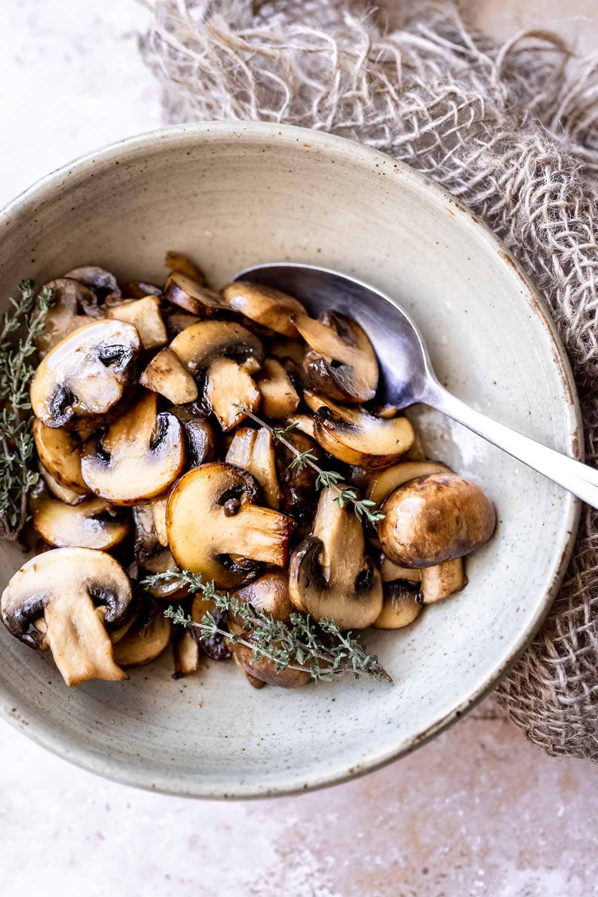 sauteed baby bella mushrooms resting in a bowl.