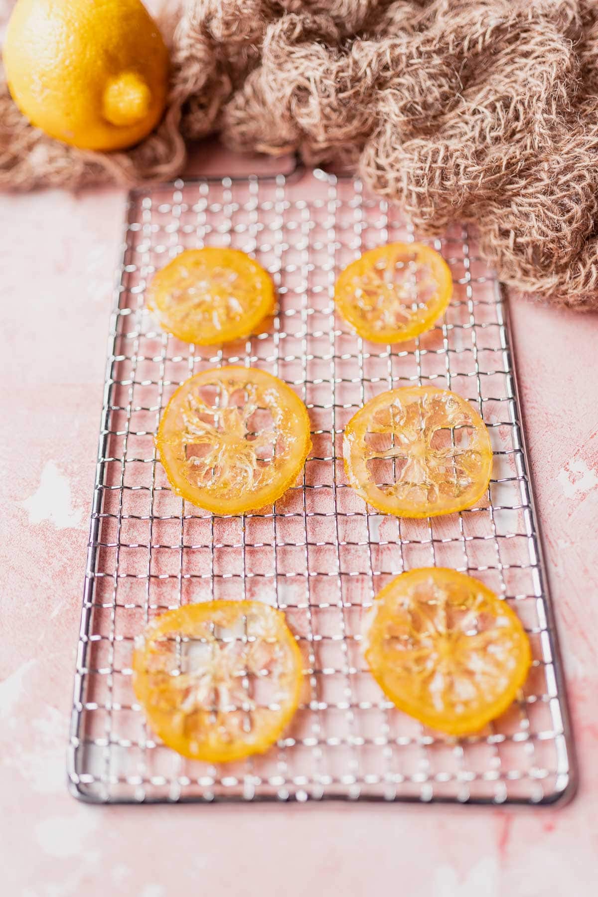 6 lemon slices rest on a small silver rack.