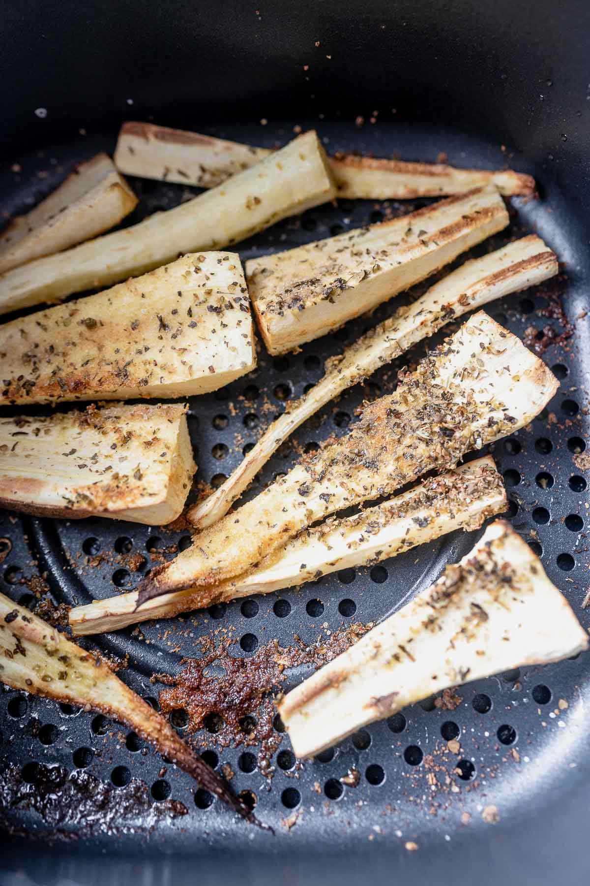 Cooked parsnips in an air fryer.