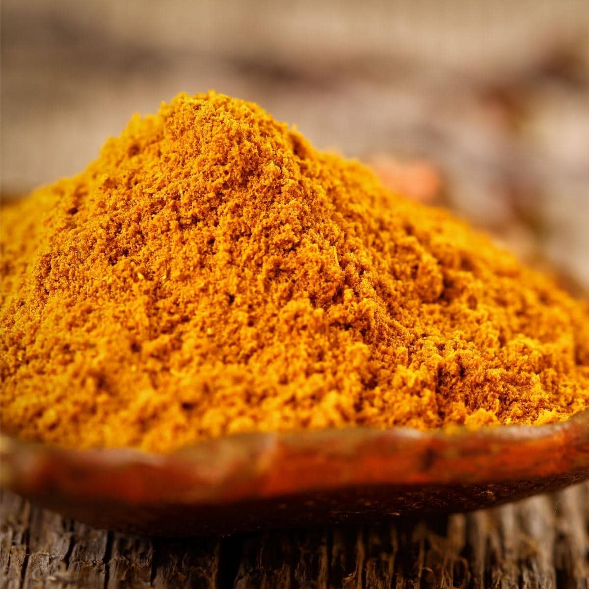 A close shot of orange curry powder.
