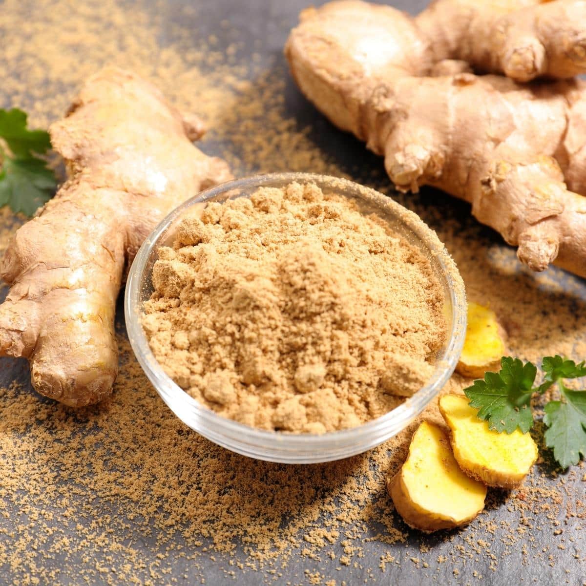 A small glass bowl of ground ginger.
