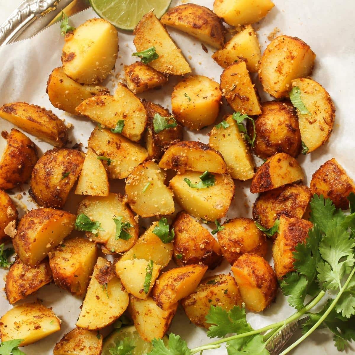 Small cubed potatoes on a white plate.