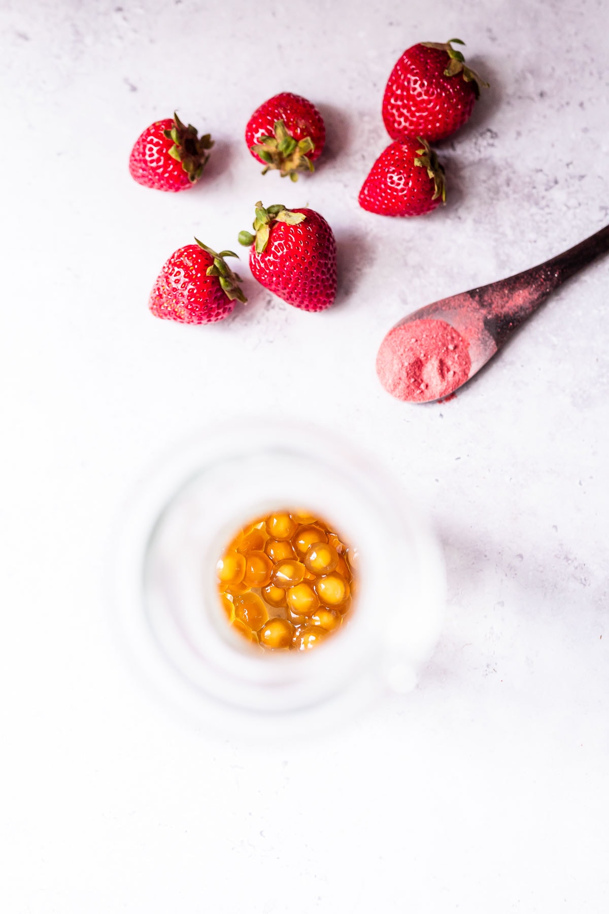 A glass filled with brown tapioca pearls.