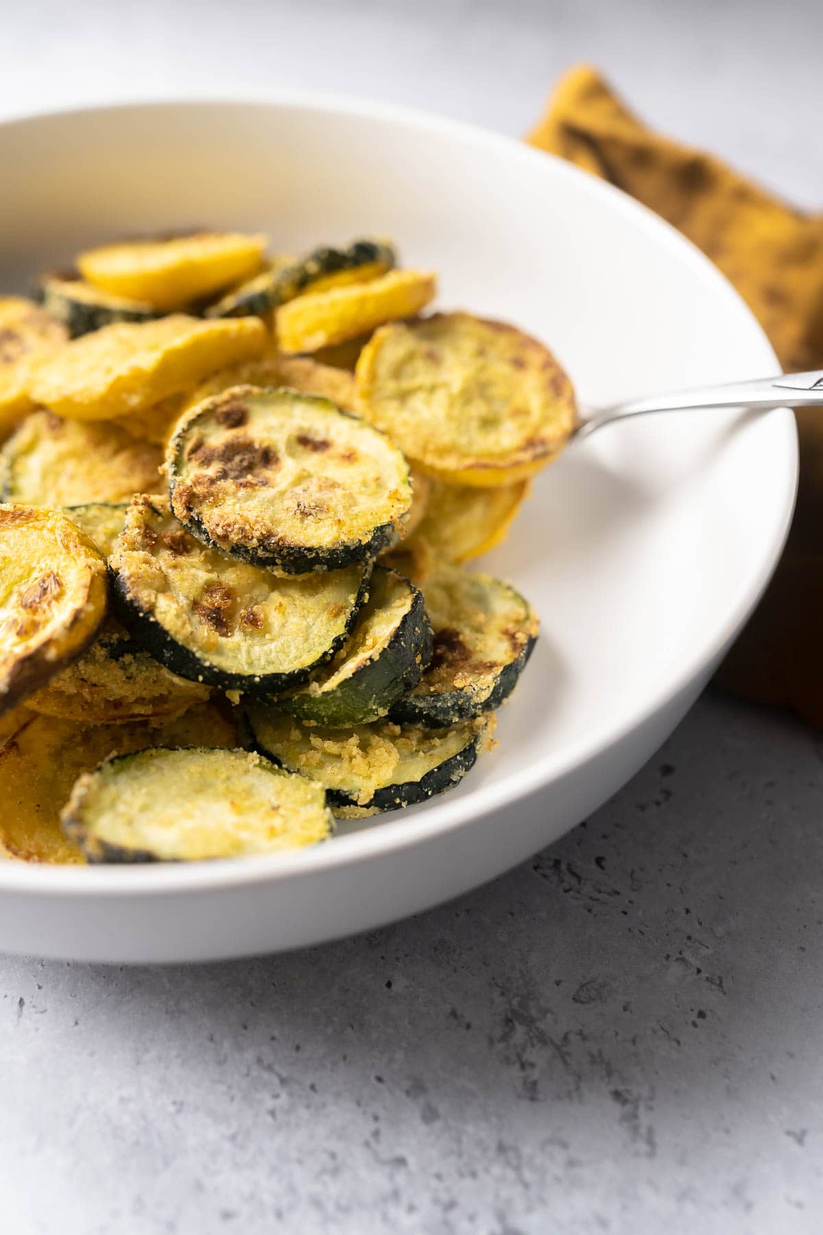 Side view of sliced squash in a white bowl.