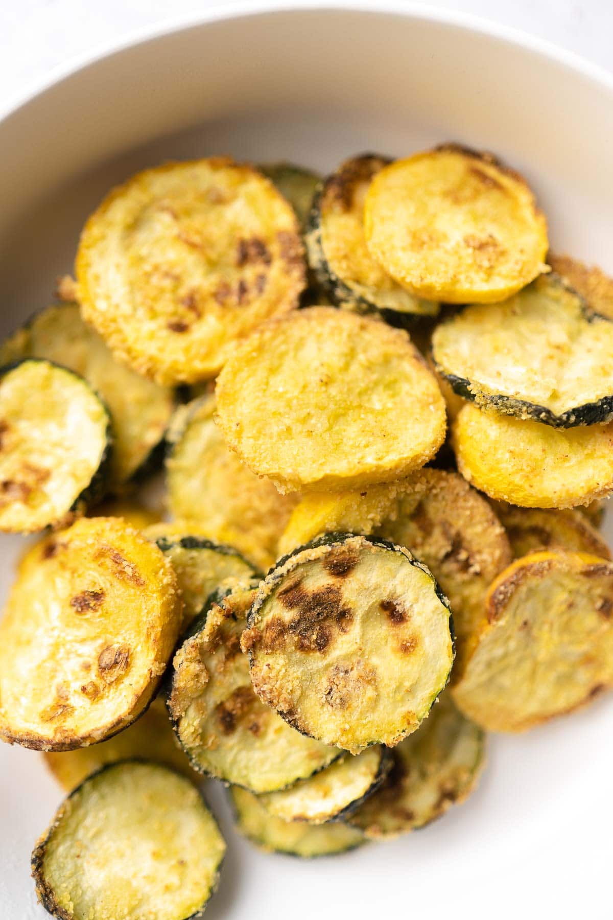 Close shots of sliced squash pieces with some browning.