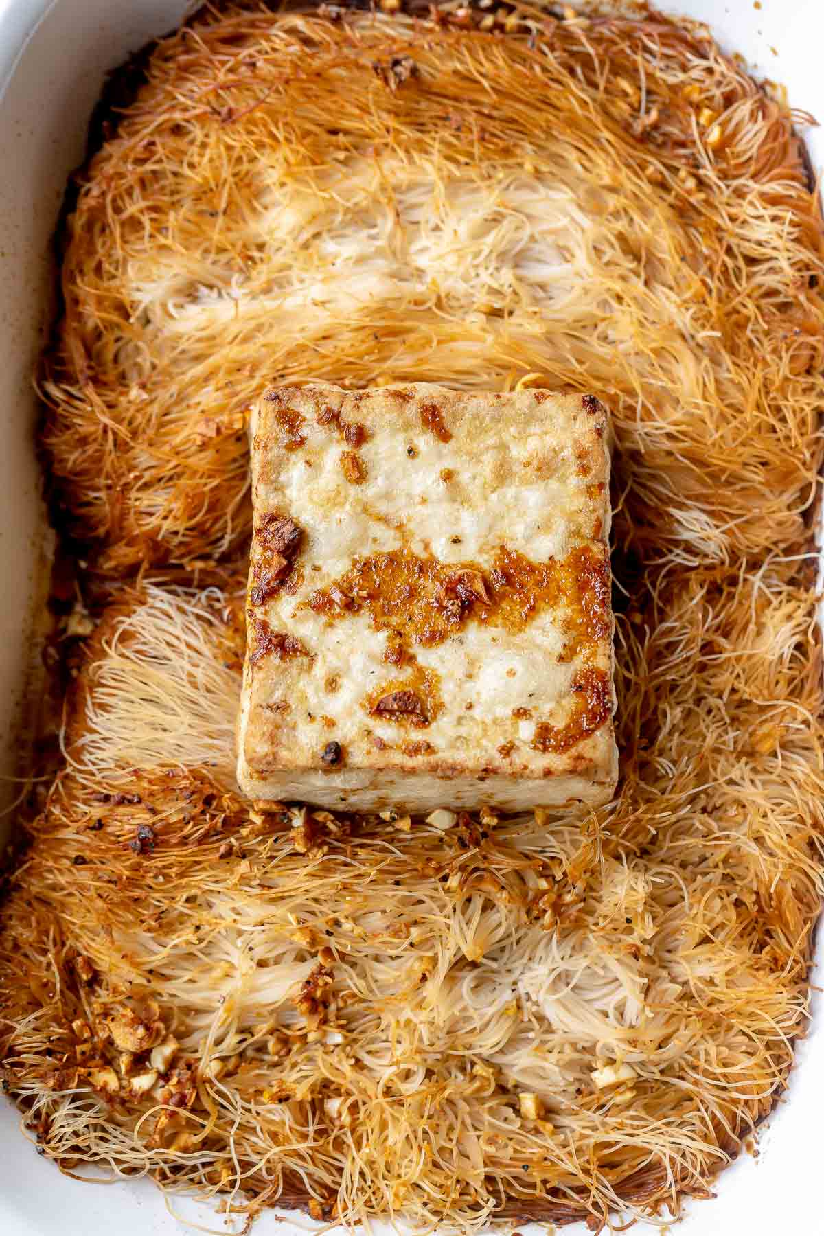 Brown cooked noodles and tofu in a large baking dish.