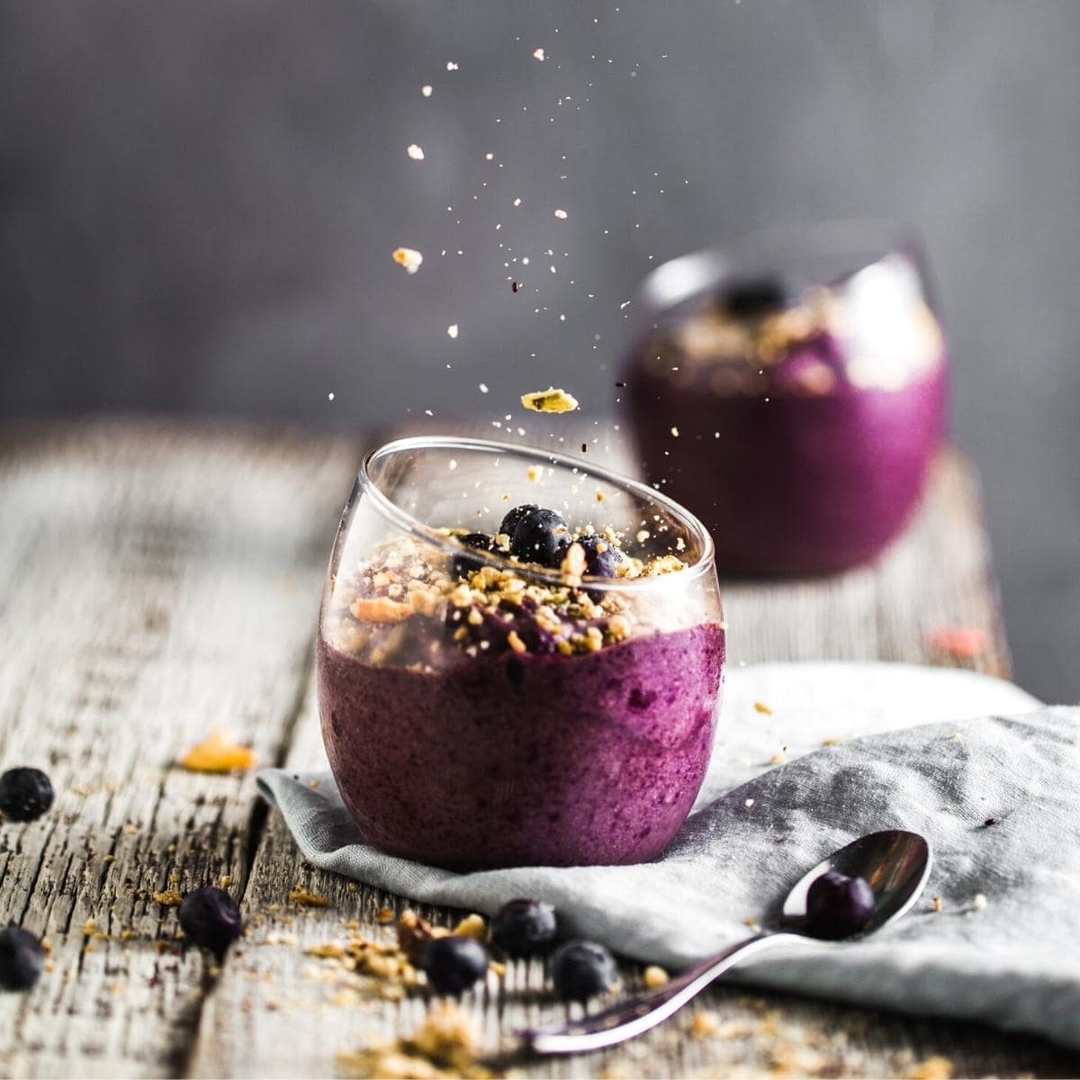 An acai dessert in a clear glass.