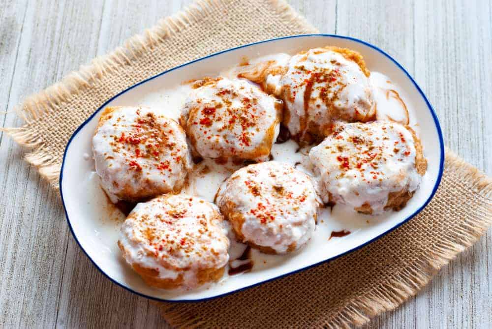 The Indian dish dahi bhalla resting on a white ceramic dish.