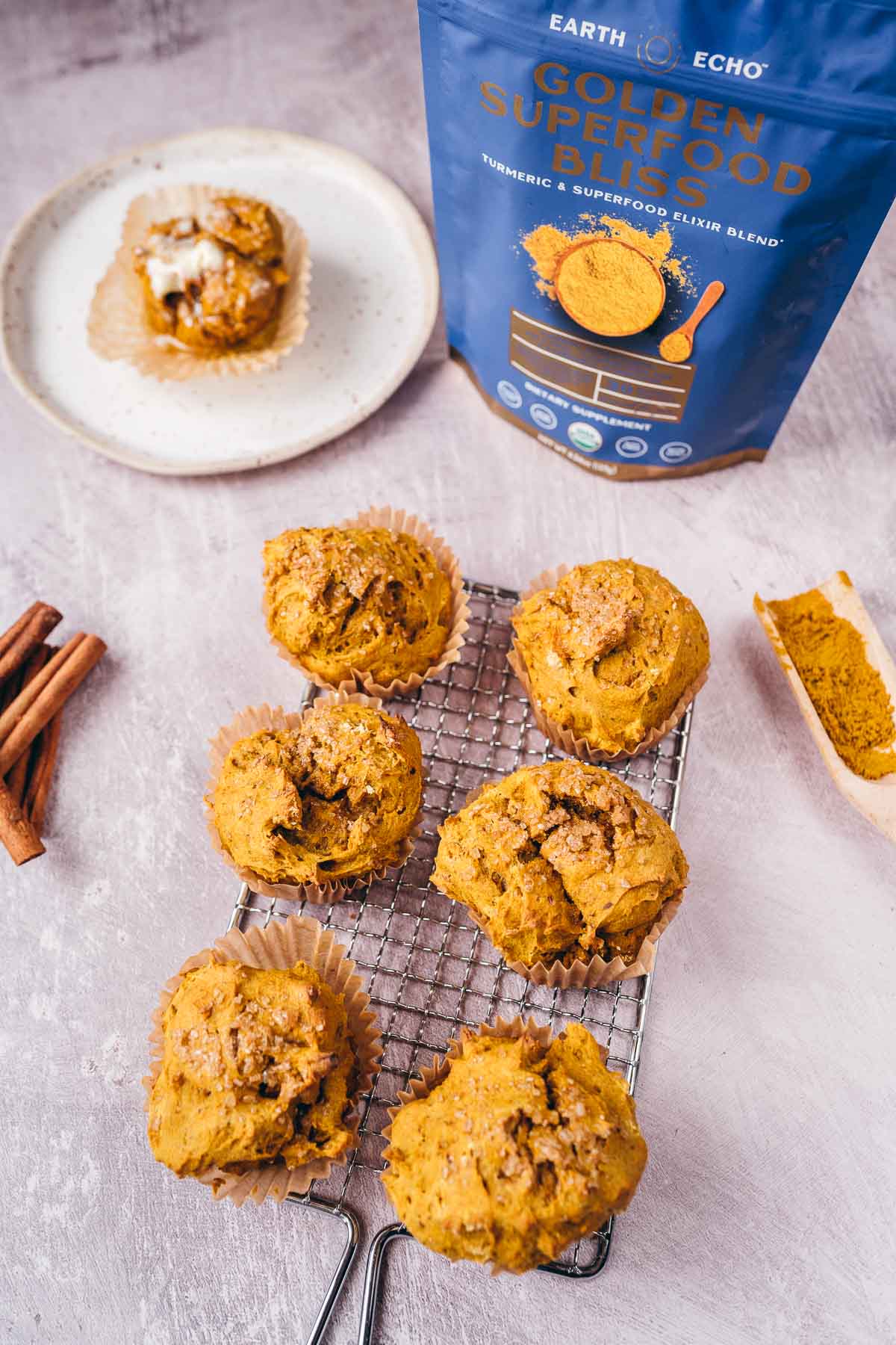 A silver rack topped with golden muffins.