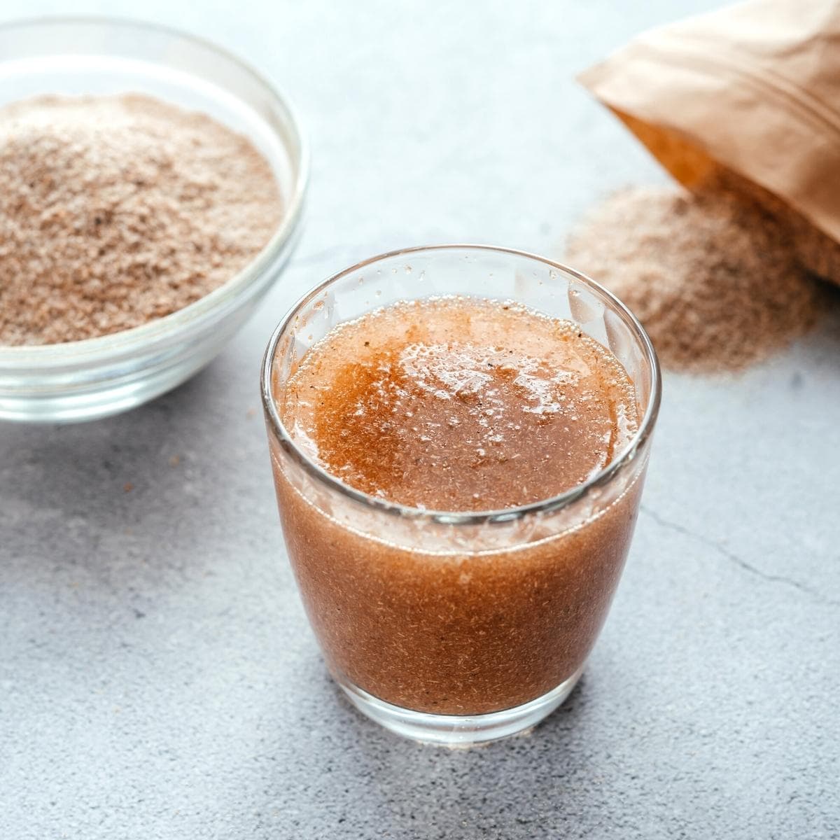 A clear glass of water mixed with psyllium husk to make a psyllium egg.