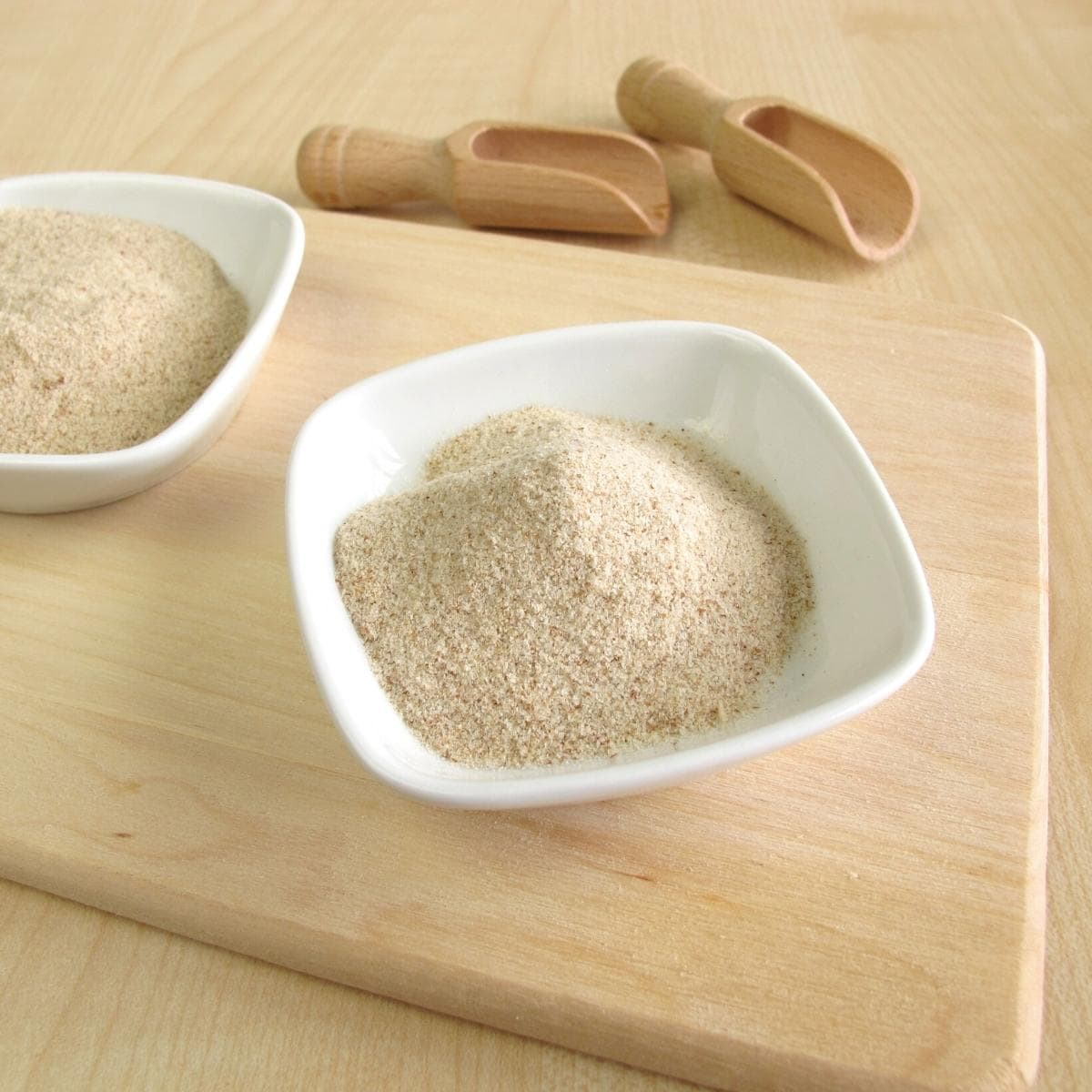 A white bowl filled with psyllium husk powder.