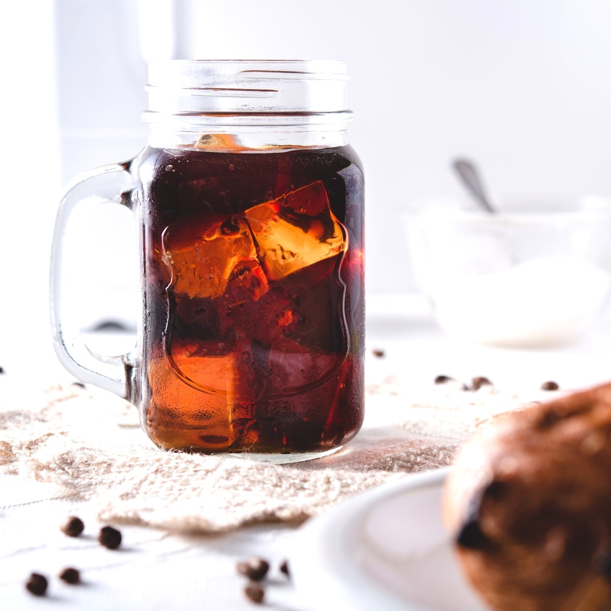 A clear glass mug filled with cold brew coffee.